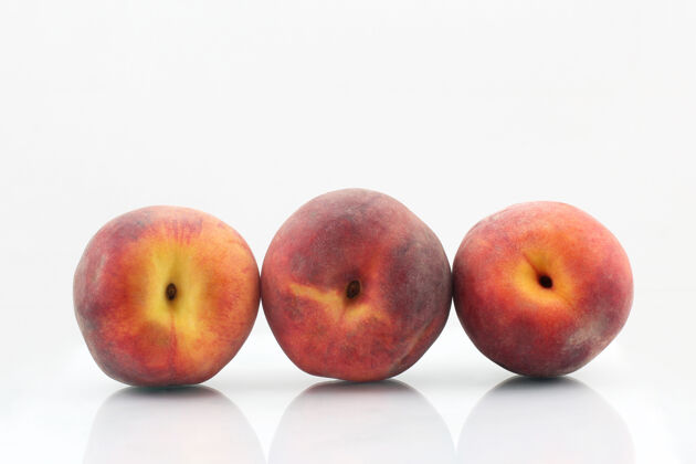 美味三个成熟的桃子在白色三甜油桃