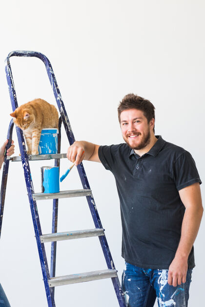 工作装修 重新装修和家庭概念-年轻人抚摸猫在装修猫配件房子