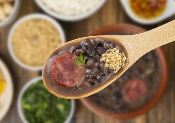 碗用勺子盛着传统的巴西菜食物培根汤匙