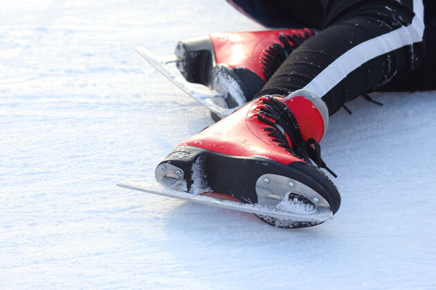 训练溜冰场上一个倒下的人穿着溜冰鞋的脚乐趣人运动