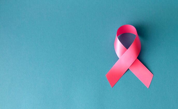 诊所绿松石表面的粉红丝带为乳腺癌的认识帮助战斗丝带
