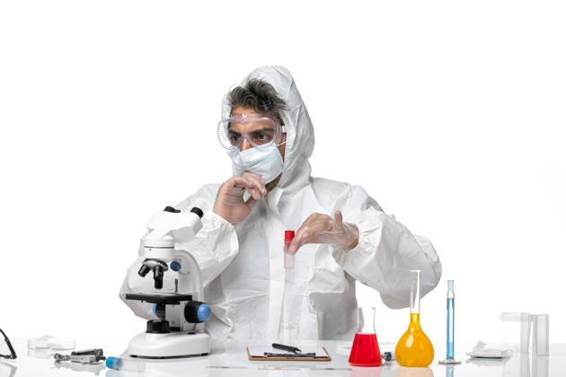 成人男医生穿着防护服 戴着口罩 拿着白色的烧瓶口罩实验室外套专业