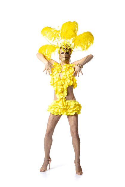 新表演身着嘉年华化装 黄色羽毛的美丽年轻女子在白色背景上翩翩起舞节日庆典 节日时间 舞蹈 聚会 快乐的概念复制空间肖像德马尔迪