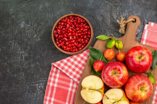 有机俯瞰石榴碗上的石榴苹果樱桃板上的桌布水果番茄桌布