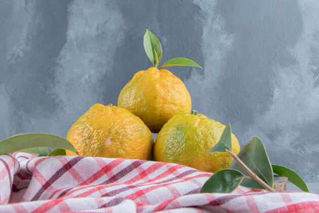 饮食大理石上毛巾上的一小堆橘子新鲜有机水果
