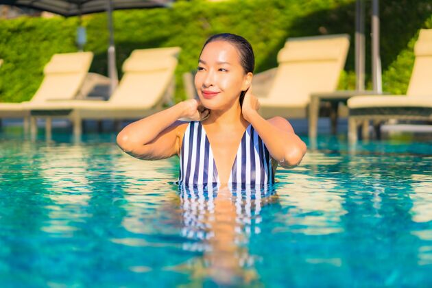 身体肖像美丽的年轻女子放松微笑休闲度假酒店游泳池周围酒店游泳池中国