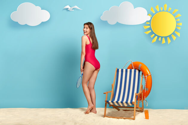躺椅苗条正身女子侧拍穿着红色泳衣 手持网球拍 在沙滩上积极休息 闲暇时光球员国家救生圈