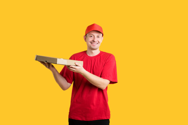 工人穿着红色制服的快乐信使手里拿着披萨帽子男孩年轻人