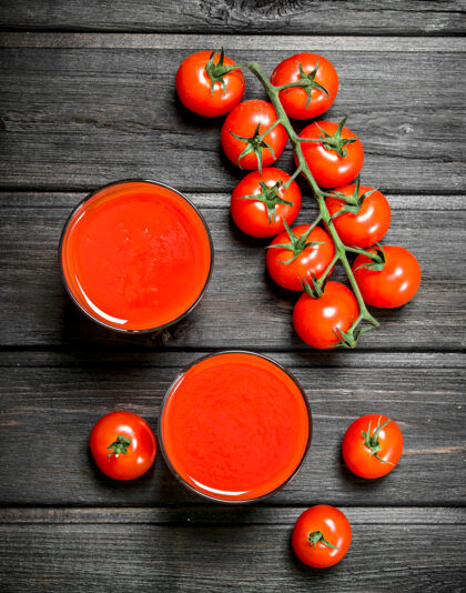 液体一杯番茄汁和一支成熟的番茄放在木桌上烹饪食物甜食