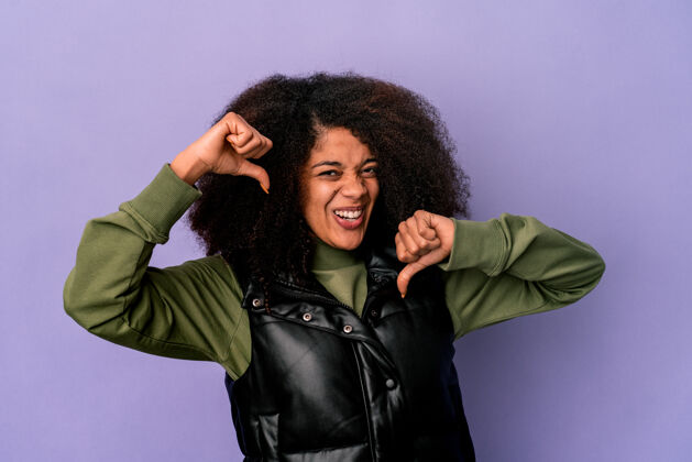 表情年轻的非洲裔美国卷发女子孤立在紫色上感到骄傲和自信 以身作则成功自信傲慢