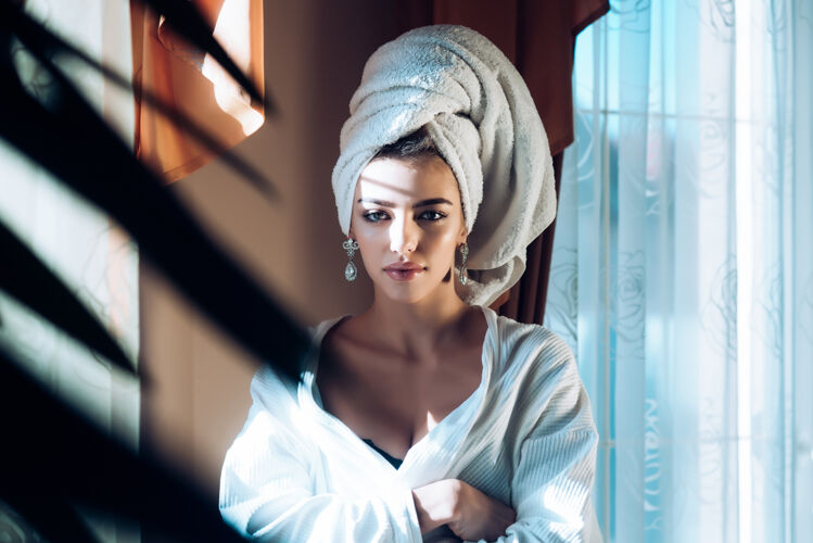 健康头上带毛巾的美女在spa或晨间淋浴后放松穿着浴衣的女士在健康和护肤程序后休息健康和护理理念之后浴室皮肤护理