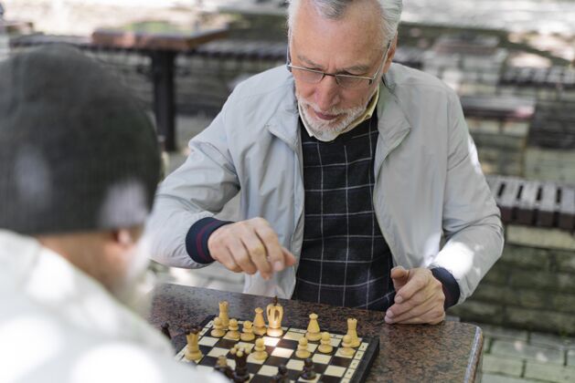 城市近距离的朋友在户外下棋老年人户外老年人