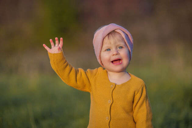 欢笑可爱的小女孩走在秋天的花园里 手里拿着一个红色的篮子苹果肖像一个快乐的女孩在明媚的秋天衣服暖和明媚的秋天公园帽子快乐
