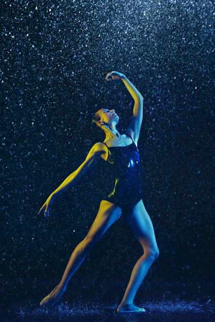 灵活年轻的女芭蕾舞演员在水滴和浪花下表演白种人模特在霓虹灯下跳舞迷人的女人芭蕾舞和当代舞蹈概念创意艺术照片体操锻炼现代