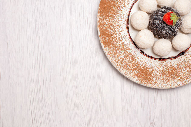 饼干俯瞰美味的椰子糖和巧克力蛋糕在白色背景上糖蛋糕饼干甜糖果饼干封闭百吉饼美食