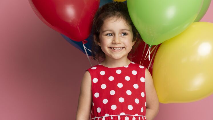 人笑眯眯的小女孩穿着红裙子庆祝生日快乐生日聚会生日