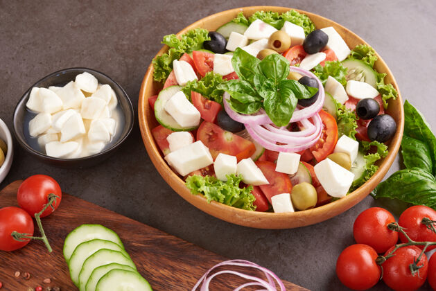 素食主义者经典的希腊沙拉 新鲜蔬菜 黄瓜 西红柿 甜椒 生菜 红洋葱 菲塔奶酪和橄榄油橄榄健康的食物 俯视图颜色顶部油