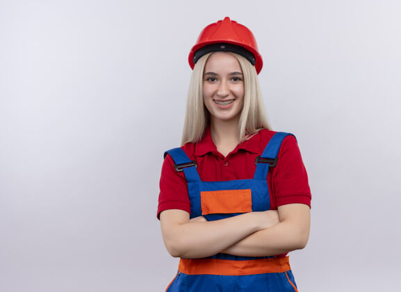 复制微笑着的年轻金发工程师建筑工女孩穿着统一的牙套站在孤立的白色空间与复制空间封闭的姿态女孩建筑工站