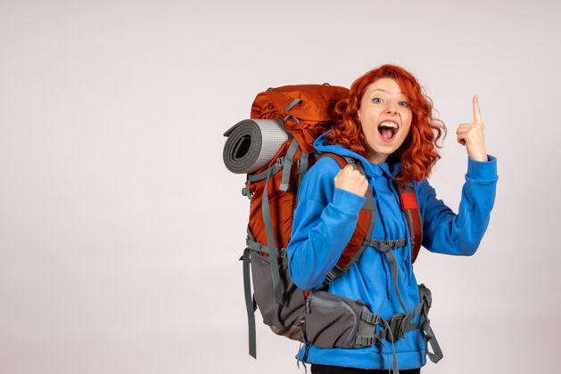 快乐女游客背着背包上山旅游自然背包肖像