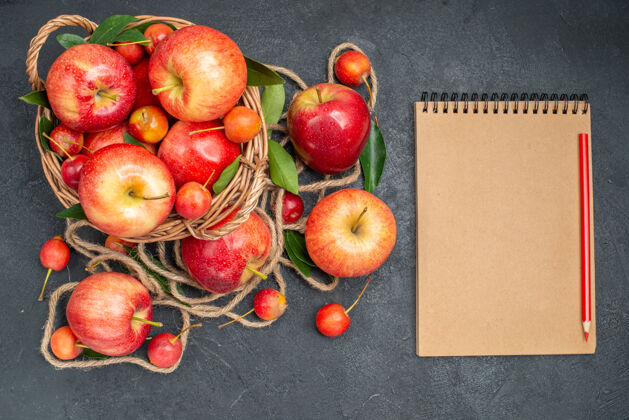 营养顶部特写查看水果篮与苹果樱桃旁边的水果和绳子笔记本铅笔多汁健康苹果
