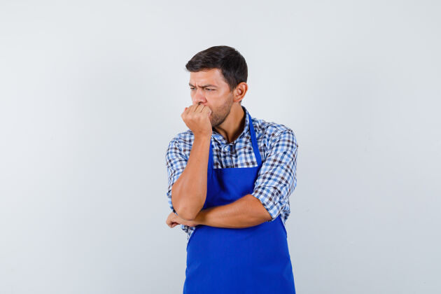 厨师穿着蓝色围裙和衬衫的年轻男厨师男士男士烹饪