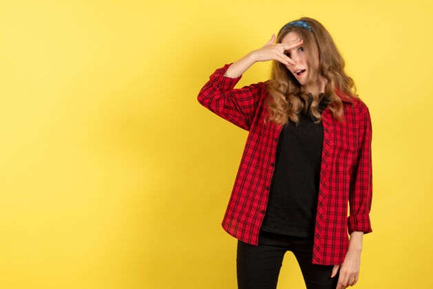 衬衫正面图穿着红色格子衬衫的年轻女性站在黄色背景上摆姿势模特儿女人色彩情感人类情感年轻的女性格子