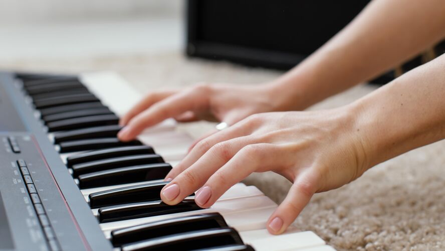女人女音乐家弹奏钢琴键盘的特写镜头艺术家音乐家天才