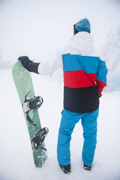 后视图冬天玩滑雪板的人运动友谊冬季运动