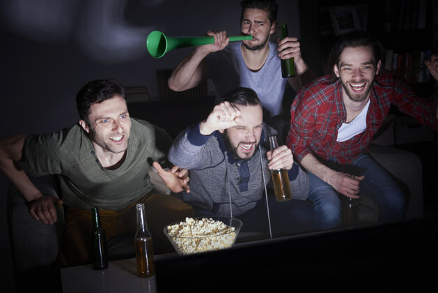 冠军一群男人在电视上喝啤酒看足球友谊足球享受