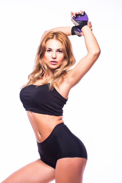 运动员一个女人在练习健身尊巴在白墙上的剪影跳舞肌肉身体模特
