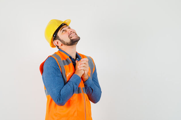 工程师穿着衬衫的年轻建筑工人双手合十祈祷工程工作安全