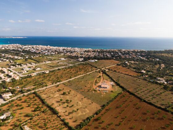 海岸空中拍摄美丽的蓝色海洋和建筑物在马略卡巴利阿里群岛在西班牙海湾海滩西班牙