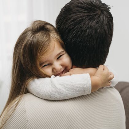 女儿笑眯眯的女儿抱着爸爸在家爸爸家庭养育