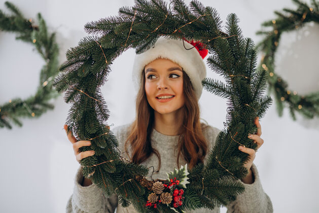 可爱圣诞节戴圣诞帽的年轻女子快乐礼物女人快乐