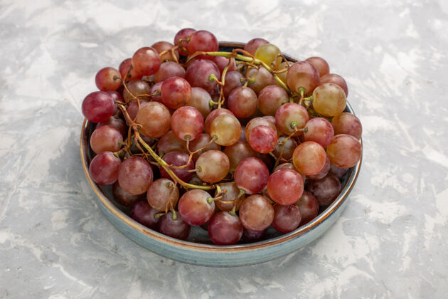 水果正面图新鲜的红葡萄多汁醇厚的甜水果上淡白色的桌子水果新鲜醇厚的果汁酒办公桌浆果葡萄酒