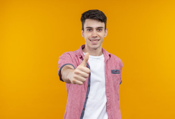 穿着笑容满面的白人年轻人穿着粉色衬衫 在孤立的橙色背景上竖起大拇指橙色拇指男人