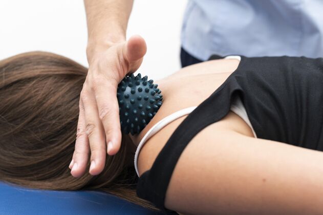治疗从理疗师那里得到按摩的女人 脖子上有球物理治疗运动学补救